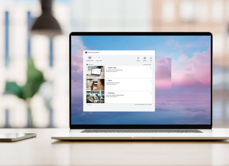 Laptop on a table: On it you can see: Desktop App Open Cloud